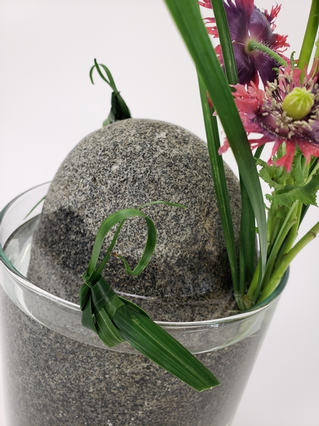 Use a rock as a floral design mechanic