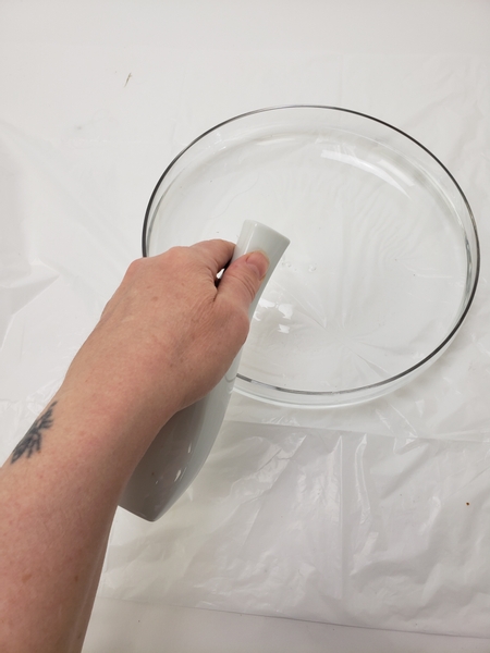 Prepare a flat display tray by filling it with water