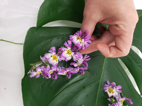 Slip the flower spike into the gap at an angle