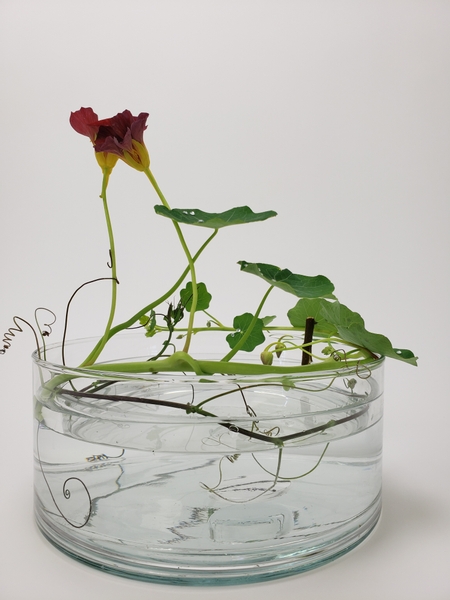 Using a double vase to keep your flowers in place in a floral design