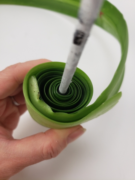 Add in more leaves if you need to create a big roll to fit snugly into the vase