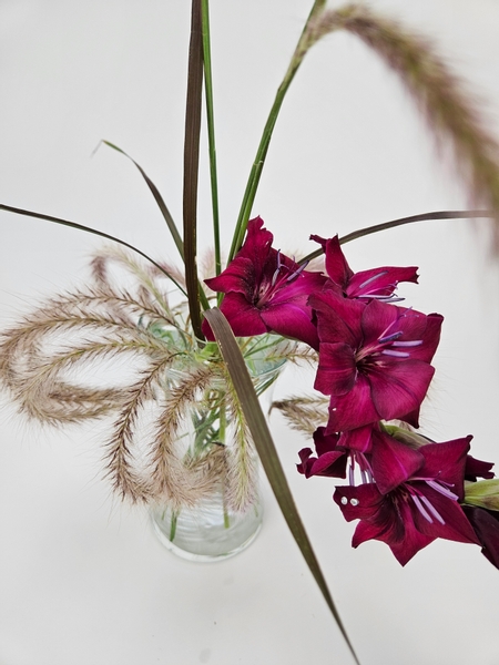 Gorgeous deep burgundy gladiolus in a sustainable floral design