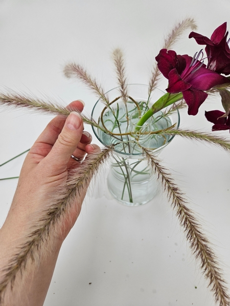 Place and secure a fountain grass stem between each of the already placed stems