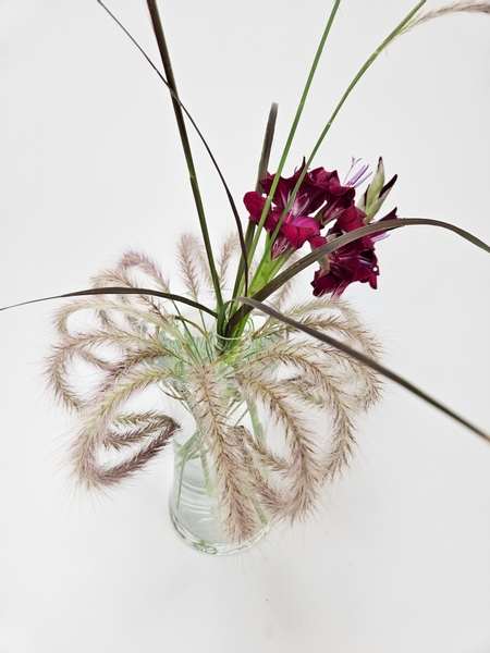 Purple fountain grass and gladiolus floral display