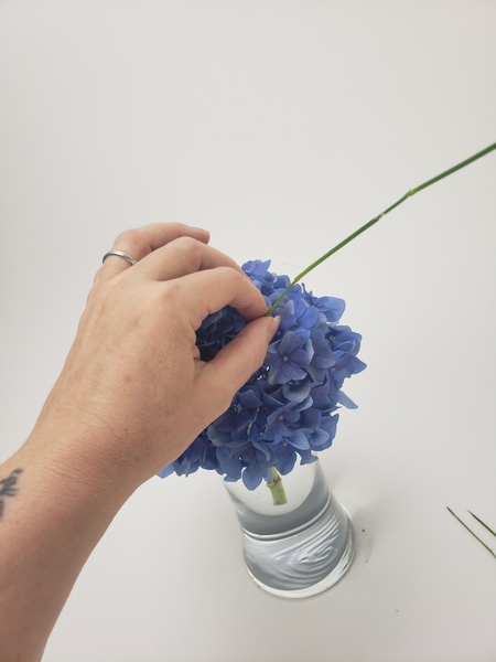 Thread the long grass through the hydrangea