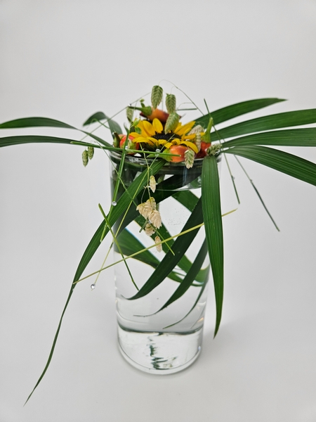 Adding chillies to an autumn flower arrangement