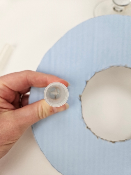 Press the bottom of a water tube into the shape