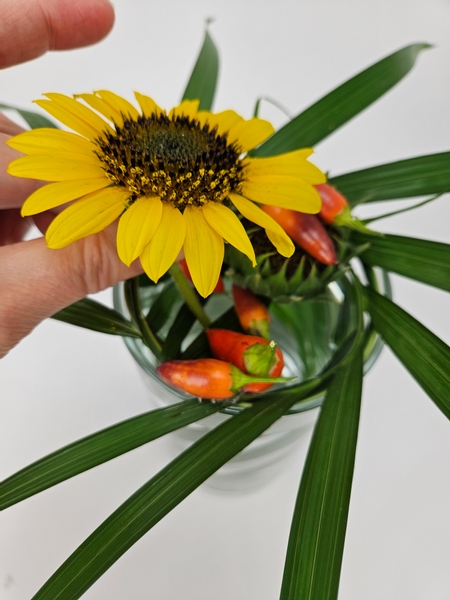 Slip in a sunflower to rest on the palm support with the stem in the water below to continue to hydrate