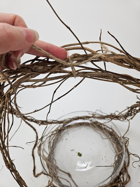 Knot the top to neaten up the wreath basket handle