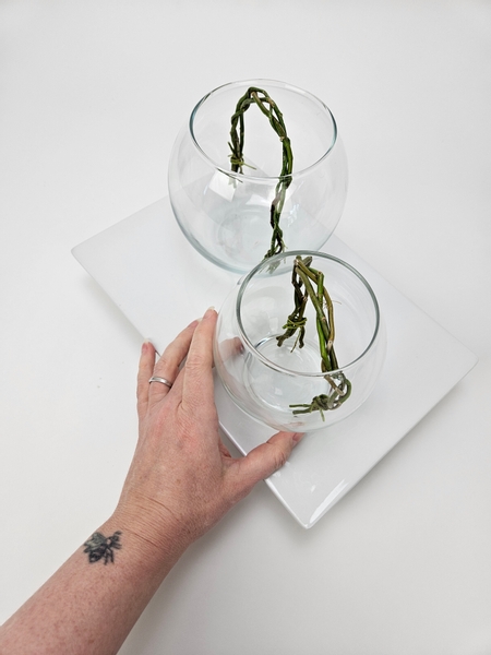 Place your fishbowl vases on a display tray to create a unit