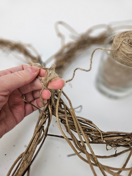 Tie the largest wreath to the side of the smaller with rope