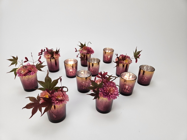 Votive glasses with flowers for autumn display