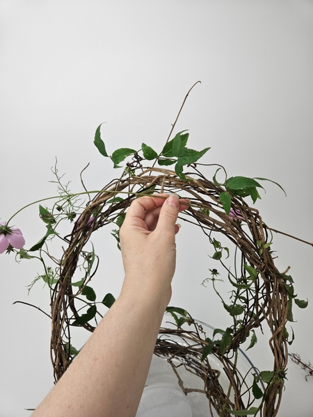 Weave the cosmos stems into the basket