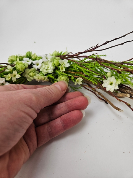 Adding flowers all the way around the garland