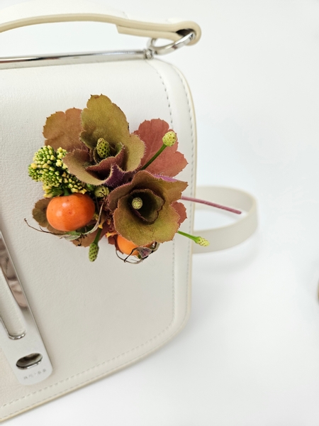 Coral bell and lantana and rosehip corsage for a handbag