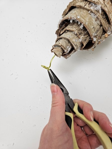 Roll the end of the wire with pliers to create a flat base