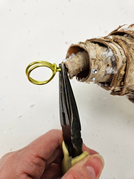 Secure the end of the wire with pliers and twist it back into the bark roll