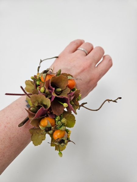 Worn as an autumn themed wrist corsage.