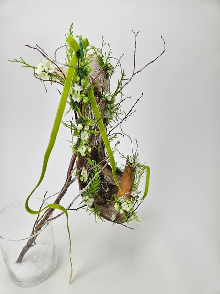 A birch bark scroll floral display for a winter wonderland Christmas theme