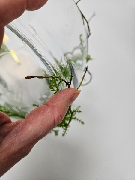 Add in a few twigs and secure to help guide the cypress