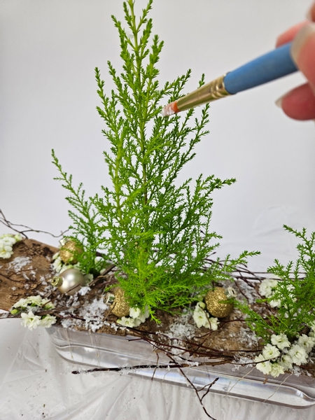 Gently brush wood glue on the cypress branches