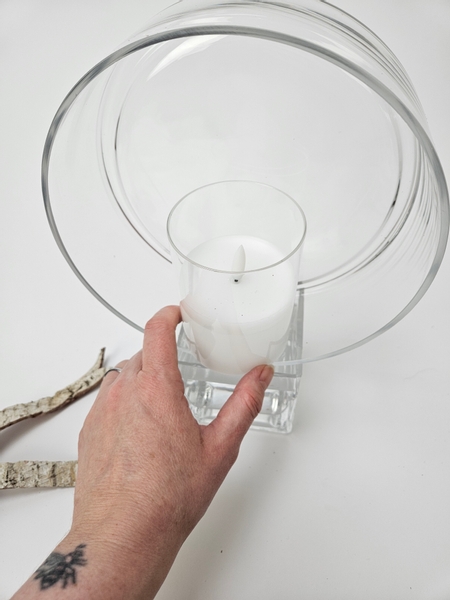 I am stacking a shallow container on to this water filled container and then fitting a flameless candle into that.