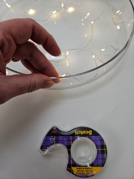 Secure the lights to the container with clear tape