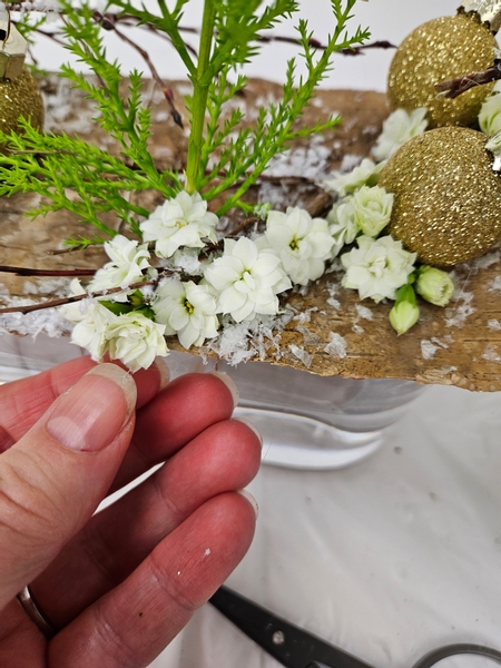 Use floral glue to add in a few Kalanchoe succulent flowers