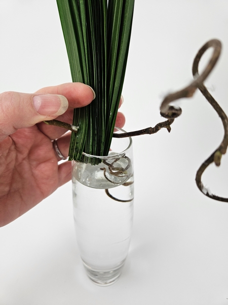 Bend the hazel twig so that it fits into the display vase