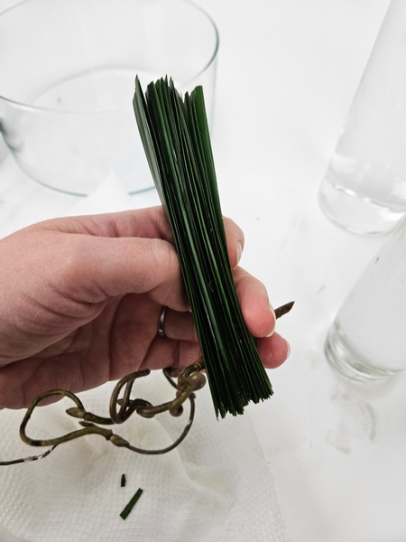 Keep the palm leaflets in a tight stack to make it easier for you to insert the twig into the display container