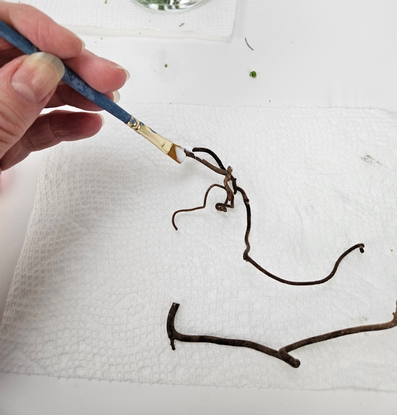 Paint a few hazel twigs with wood glue and sprinkle on some artificial snow