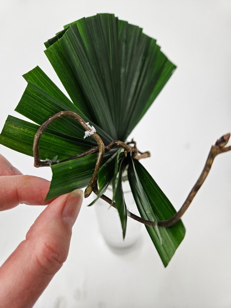 Thread the palm leaflets through the hazel twig