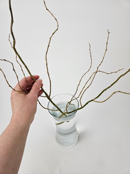 Cut the willow stems short so that the side branches can be woven into a nest for the top container to snuggle into