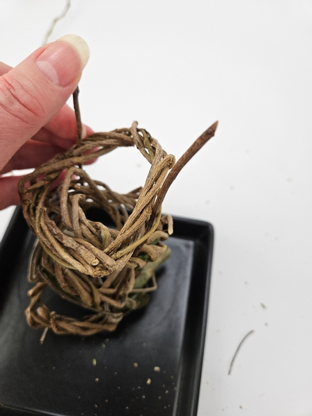 Skewer in the rest of the tiny dried wreaths to fill up the twigs