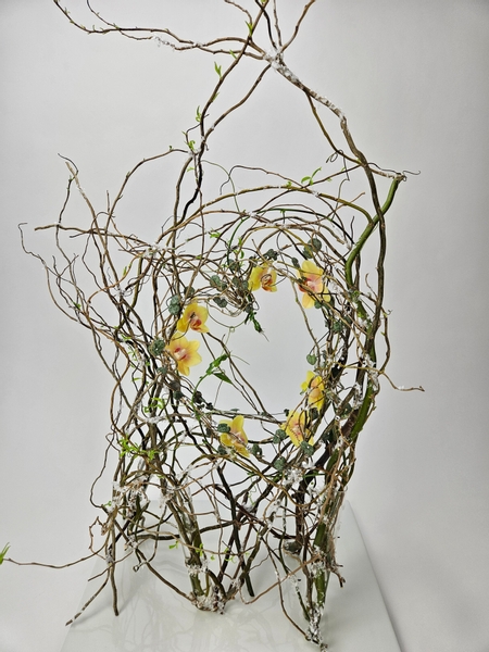 Using a glue technique to secure twigs into a heart shaped structure or armature