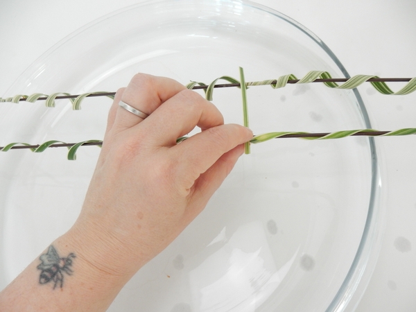 Glue in a few grass supports to connect the two wires