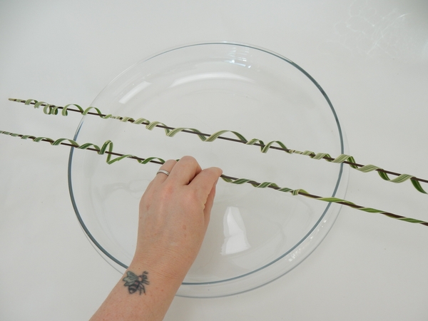 Place the grass streamers and wire across a low container