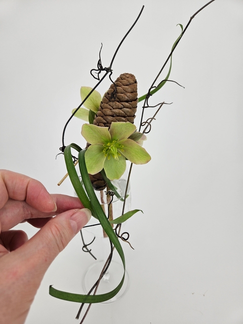 Close an open pinecone to use as a flower frog