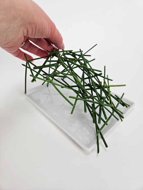 Stack miniature roses on to stacked grass snippets