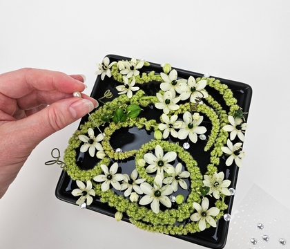 On a line pavé inspired floral design for a cooling water summer display