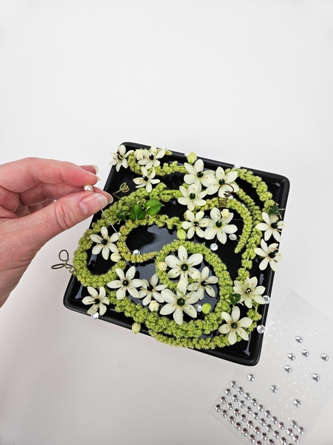 On a line pavé inspired floral design for a cooling water summer display