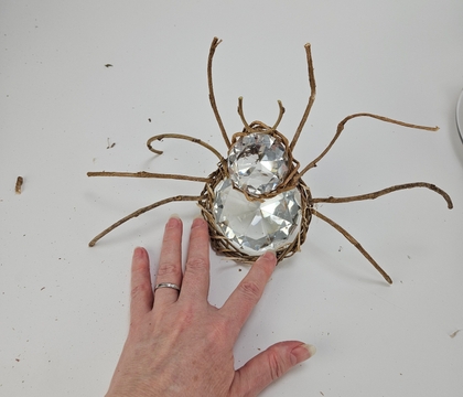 Incy Wincy Sparkle spider with a spicy wreath all around beside her